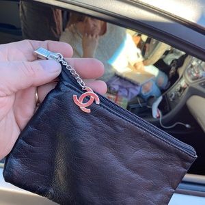 Black Chanel accessories bag with the chrome channel zipper .